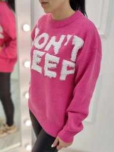 Close-up of magenta knit sweater with white toweling embroidery text on the chest