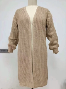 Detail of camel chunky knit texture and ribbed cuffs on a long loose cardigan
