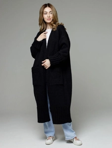 Detail of loose knit texture and large front pocket on long black cardigan for women
