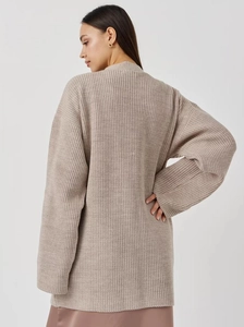 Detailed back view of an oversized oatmeal knit cardigan with textured lantern sleeves