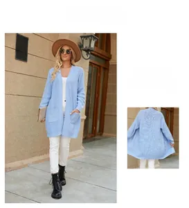 Detail of light blue knit cardigan with V-neckline, cable-knit texture, and front pockets