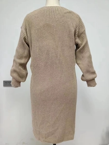 Detail of long sleeve knit dress in beige featuring thick texture and ribbed cuffs