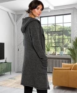 Detail of dark gray hooded long knit cardigan with large side pockets in home setting