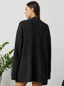 Macro detail of charcoal grey oversized knitted cardigan showing ribbed texture and back fit