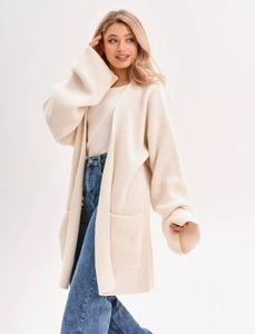 Detail of loose knit cardigan texture with functional side pockets and drop shoulder style