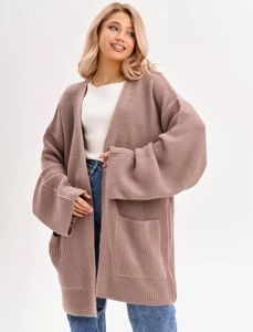 Detail of oversized knit cardigan with large pockets in soft pink mauve tones