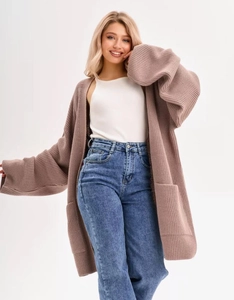 Detail of loose knit cardigan texture with front pockets and relaxed dropped shoulder