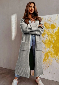 Detail of grey oversized knit cardigan showing large pockets and wide ribbed cuffs