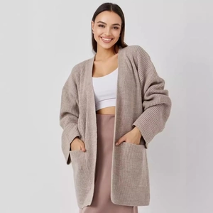 Women's oversized beige knitted cardigan with long sleeves and large front pockets
