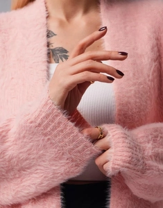 Detail of pink faux mink fur cardigan with soft fluffy texture and knit craftsmanship