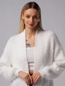 Close-up of soft white faux mink fur texture and ribbed cuffs on a knit cardigan
