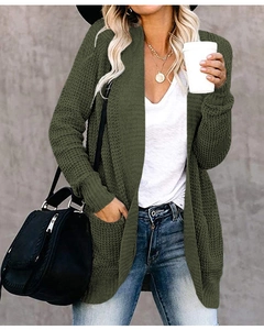 Close-up of forest green waffle knit cardigan featuring practical side pockets