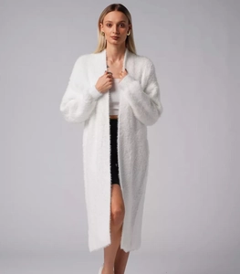 Detail showing soft white faux mink fur texture and loose knit of the long cardigan