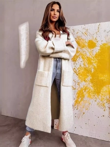 Beige oversized long knit cardigan sweater with large front pockets and rolled sleeves