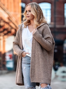 Detailed texture of an oversized hooded knitted cardigan with ribbed cuffs in oatmeal