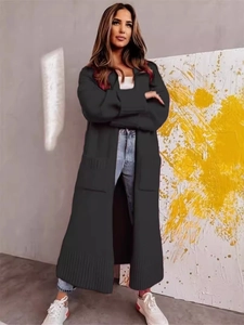 Women's loose long black knit cardigan with large pockets and ribbed cuffs