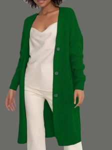 Detail of dark green knit cardigan featuring large side pockets and matching buttons