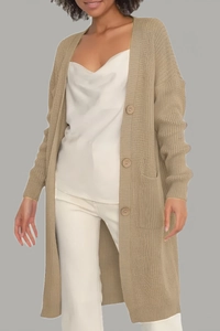 Detail of warm camel knit cardigan with large buttons and functional patch pockets