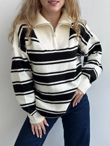 Detail of half-zip collar and black and white striped texture on knit sweater