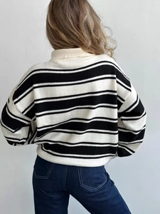 Detail view of the striped oversized knit sweater with drop shoulders and a high collar