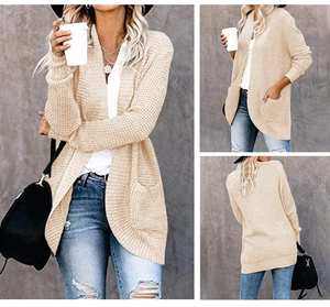 Detailed macro view of beige knit cardigan texture and large functional side pockets