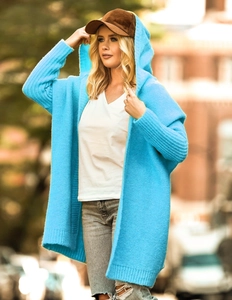 Close-up of bright blue hooded knit cardigan with a chunky texture and loose batwing style
