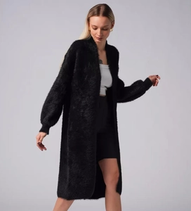 Detail of black faux mink fur cardigan with puffy lantern sleeves and soft knitted texture