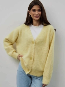 Detail of soft yellow mink-like knit cardigan featuring large V-neck and ribbed cuffs