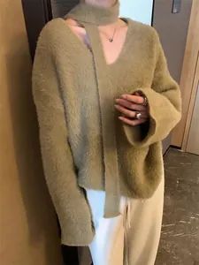 Detail of soft olive green knit sweater with matching scarf made of fluffy faux mink fur