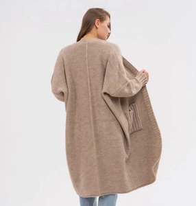Detail of camel chunky knit cardigan showing thick texture and large side pockets