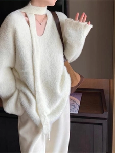 Detail view of cream faux mink fur knit sweater with soft texture and matching scarf detail
