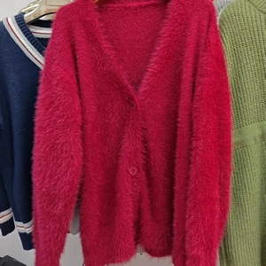 Detail of rose red long plush knit cardigan featuring deep V-neck and soft fuzzy texture