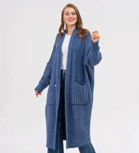 Detailed close-up of blue knit cardigan featuring ribbed cuffs and large patch pockets