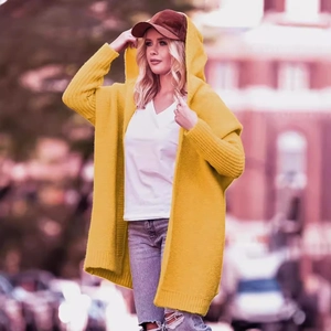 Bright yellow hooded knit cardigan with long sleeves in a relaxed street style look