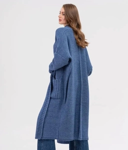 Detail of dark blue knit cardigan showing vertical rib texture and deep side pockets