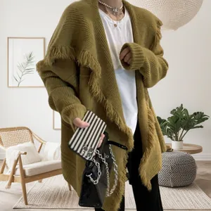 Detailed close-up of dark green knitted cardigan featuring wide lapels and long tassel trim