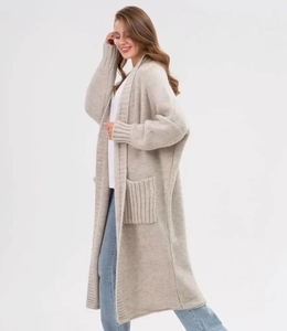 Detail of oatmeal knit cardigan showing ribbed cuffs and large functional side pockets