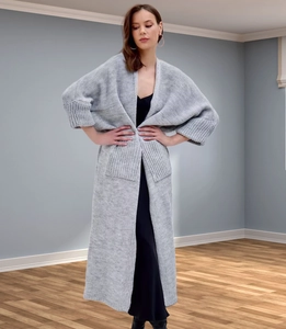 Detail of light grey oversized knitted long cardigan with ribbed texture and drop shoulders