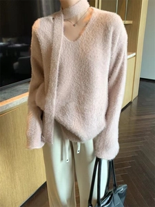 Detail of pink faux mink v-neck sweater with matching scarf showing fuzzy texture