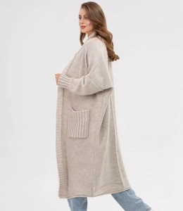 Detail of light grey knit cardigan showing waffle texture, drop shoulder, and large side pocket
