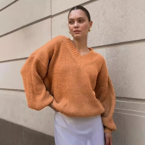 Cozy oversized V-neck knit sweater in warm apricot with drop shoulder design for women