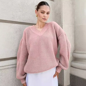Oversized V-neck pink chunky knit sweater featuring drop shoulder and ribbed cuffs