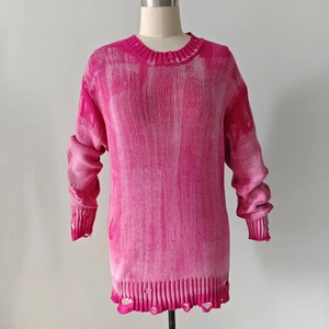 Detail of distressed knit texture on pink oversized sweater with ripped effects