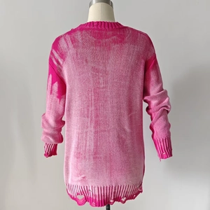 Distressed pink oversized knit sweater showing detailed frayed hem on a white mannequin