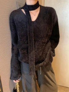 Detail of black faux mink sweater featuring a V-neckline with trendy choker strap design