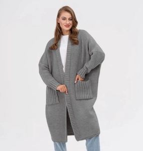 Detail of gray knit cardigan featuring chunky texture and large front pockets