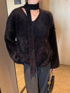 Detail of black faux mink sweater showing unique halter neck design and shoulder cut-outs
