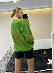 Distressed fruit green oversized knit sweater with artistic ripped detailing on the back