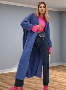 Detail of royal blue chunky knit cardigan featuring ribbed cuffs and large side pockets