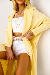 Detail shot of bright yellow long knit cardigan with textured fabric and drop shoulder design